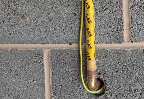 gas pipe installed through a block wall